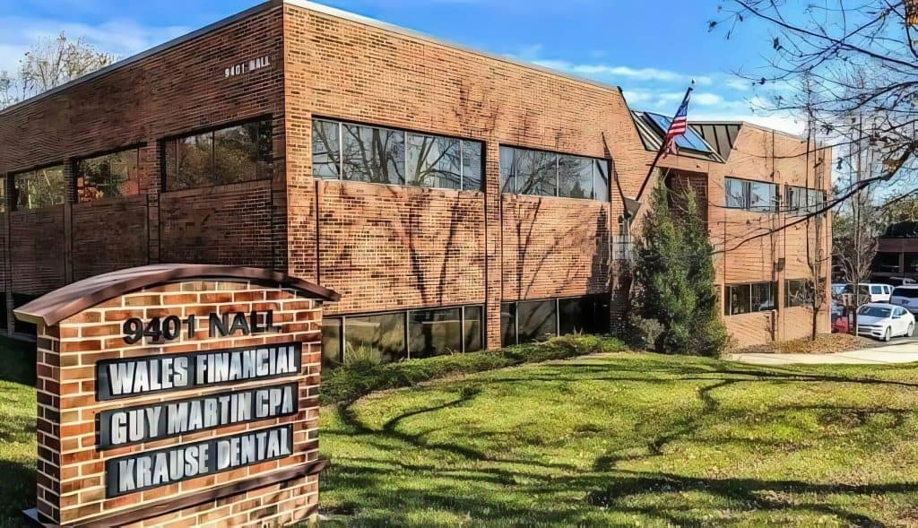 A brick building with a sign in front of it.